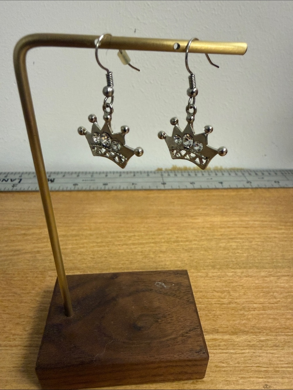 Silver tone crown dangle drop earrings with crystal accent
